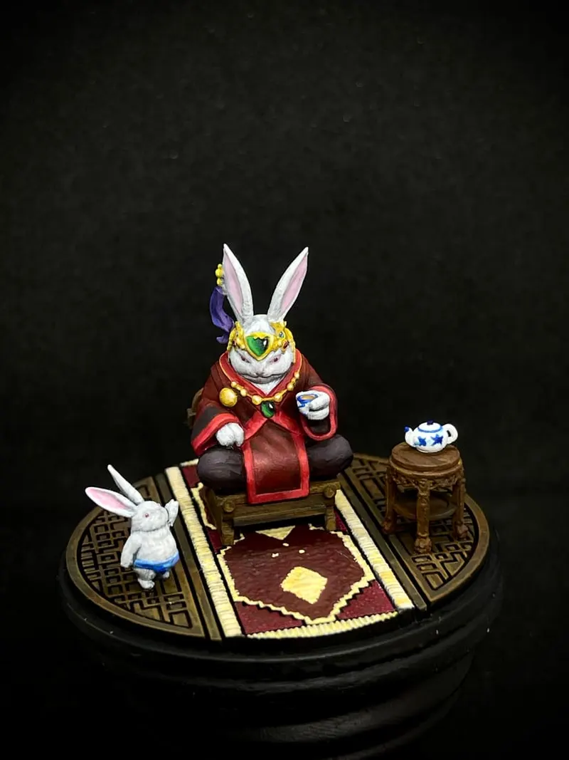 A rabbit in a red robe serving tea on a patterned rug